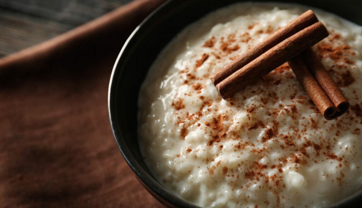 Delicious rice pudding with cinnamon in bowl, closeup