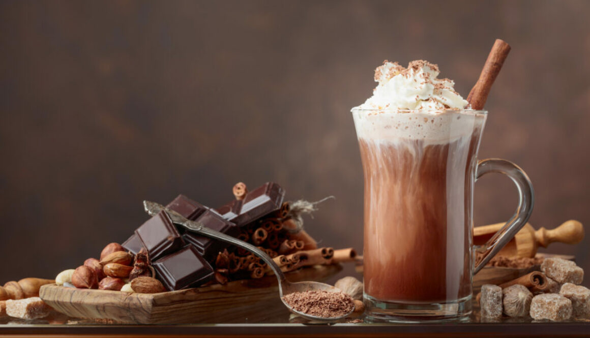 Hot chocolate with cream, cinnamon, chocolate pieces and various