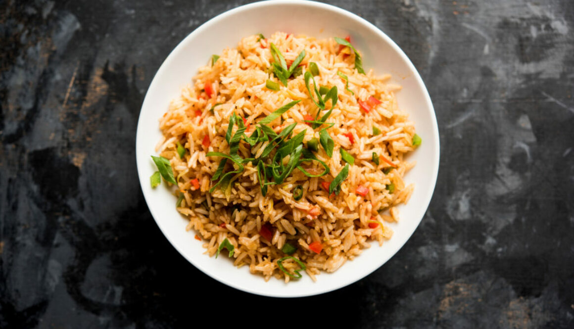 Schezwan Fried Rice Masala is a popular indo-chinese food served in a plate or bowl with chopsticks. selective focus