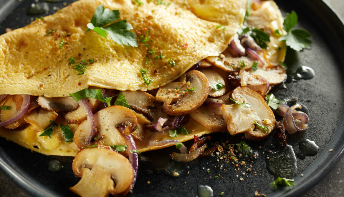 Tasty omelette with mushrooms on plate