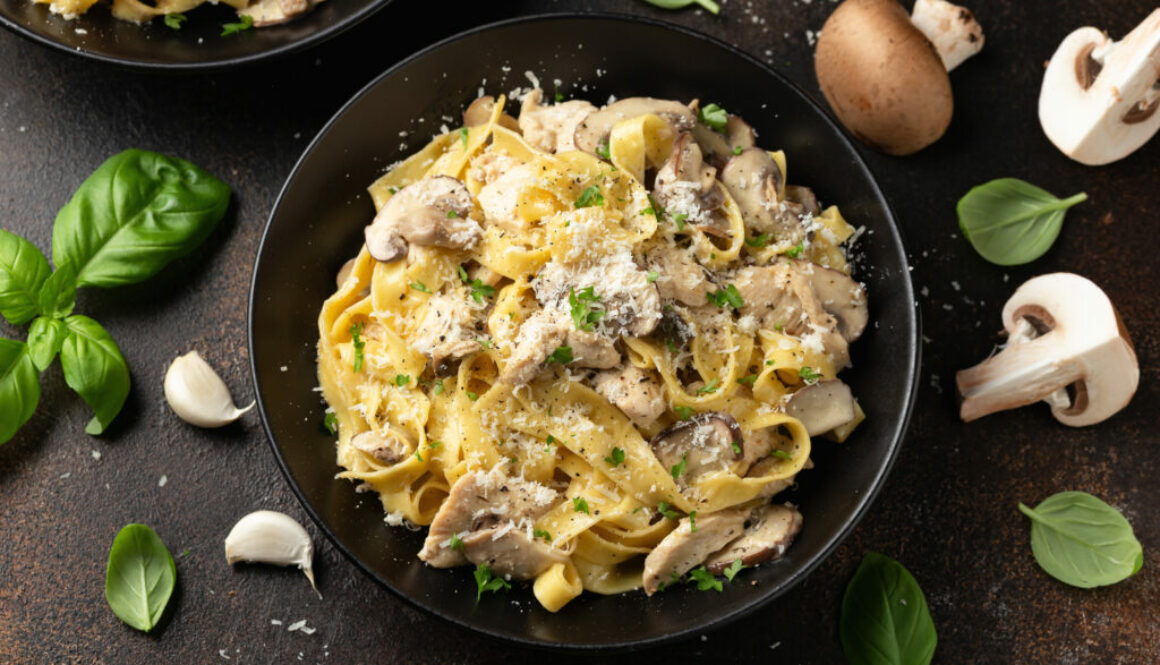 Creamy Alfredo pasta with chicken, mushrooms and parmesan cheese. Healthy Italian food